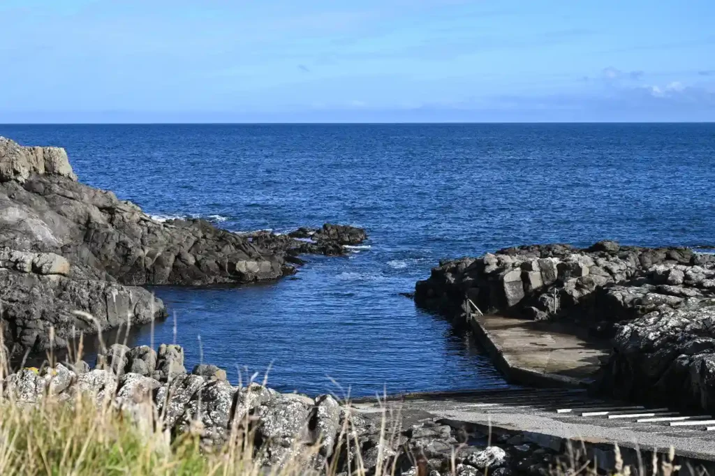 Rocky coastal inlet and boat ramp at Æðuvík on the Faroe Islands