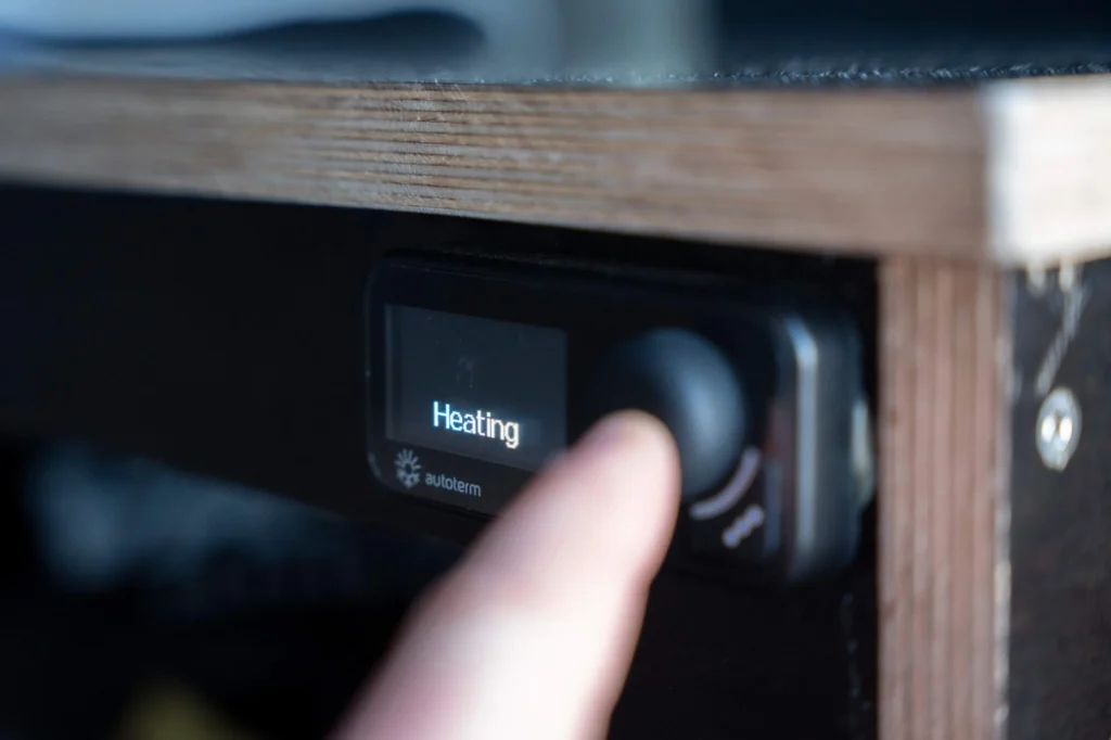 Campervan heating control panel being turned on – warm travel in the Faroe Islands