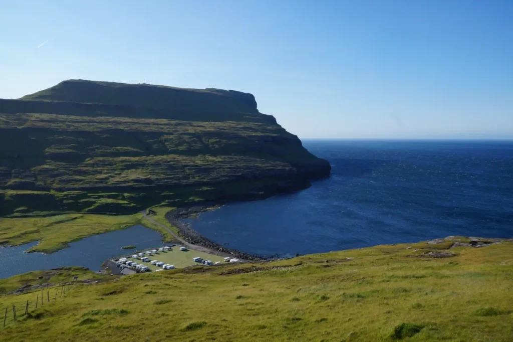 Scenic coastal campground at Eiði on the Faroe Islands, surrounded by cliffs and ocean views