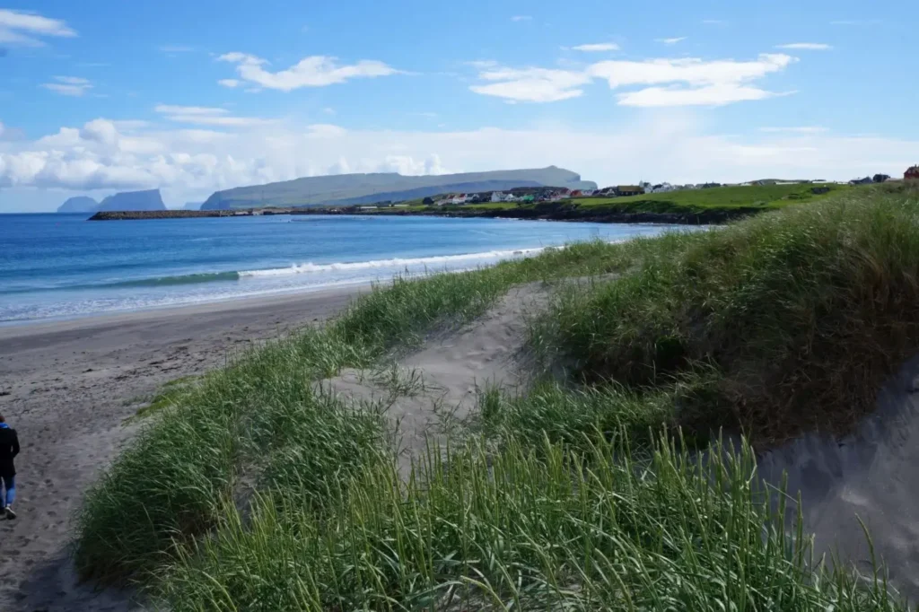Beach dunes and village of Sandur on Sandoy island, Faroe Islands