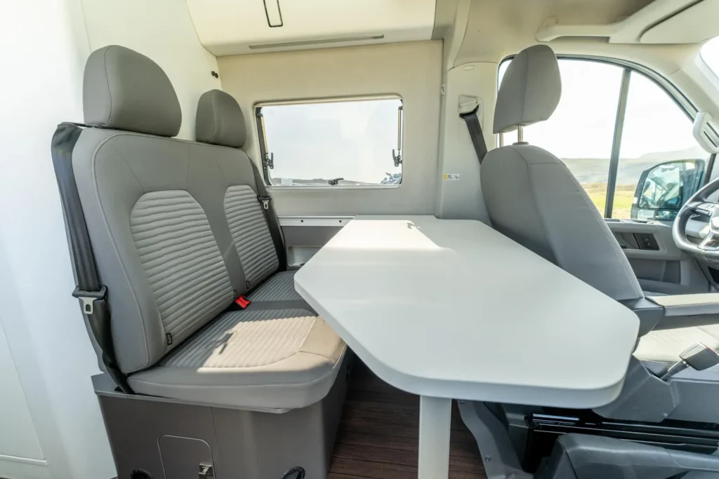 Campervan interior with dining table and seating area