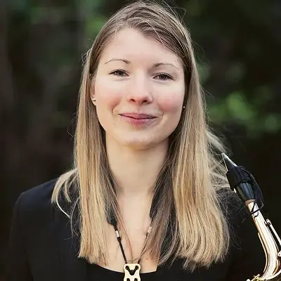 Kristina Thede Johansen holding a saxophone during an outdoor portrait photoshoot