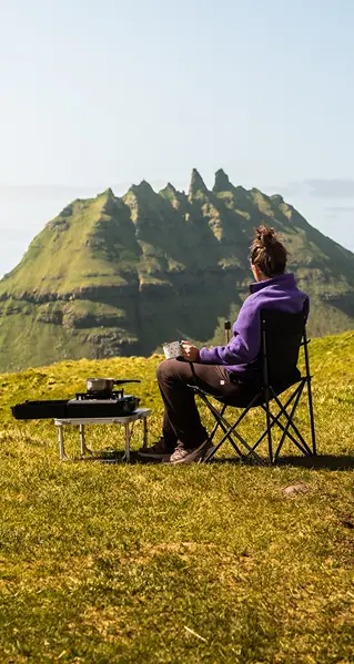 Person camping with outdoor stove in the Faroe Islands