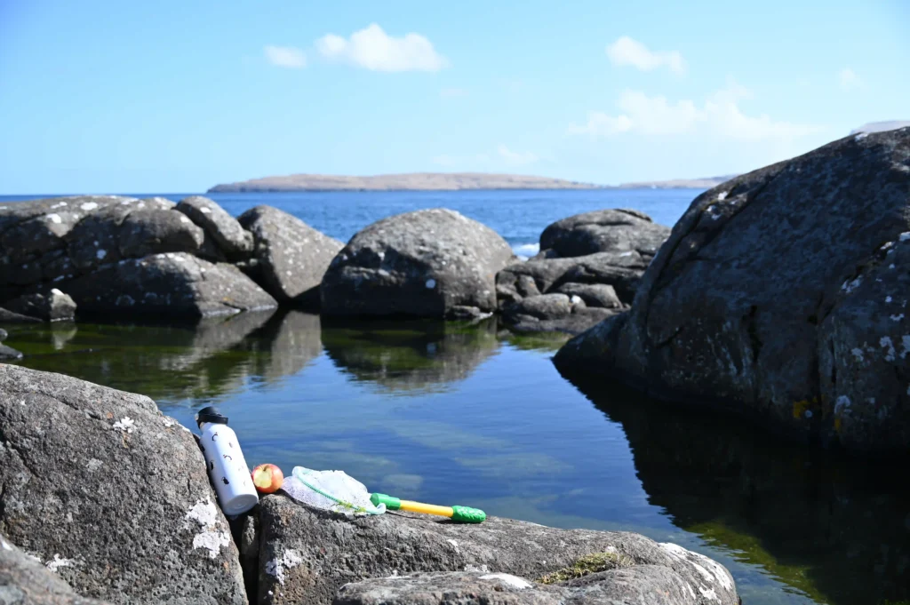 Children’s fishing net by tidal pool on Faroe Islands beach
