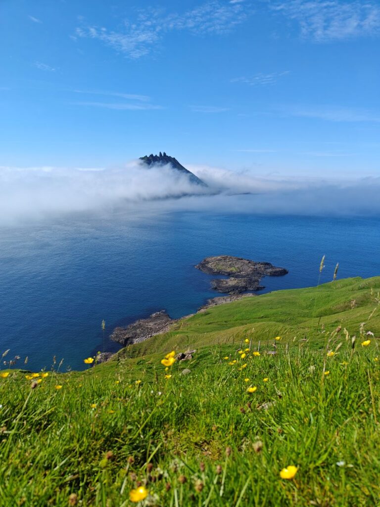 View of Tindhólmur surrounded by ocean and cliffs in the Faroe Islands