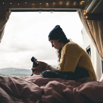 Girl Camper Van Faroe Islands A girl relaxing in her camper van rental in the Faroe Islands
